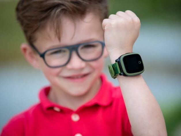 Child wearing a Spotter GPS watch while playing outside